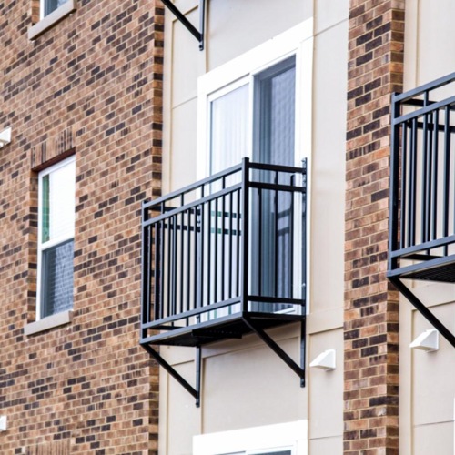 a couple of balconies on a brick building