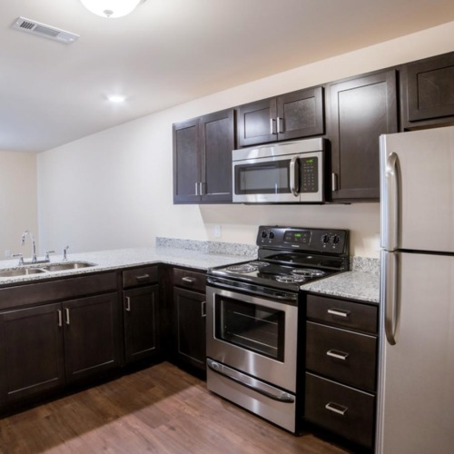 a kitchen with black cabinets